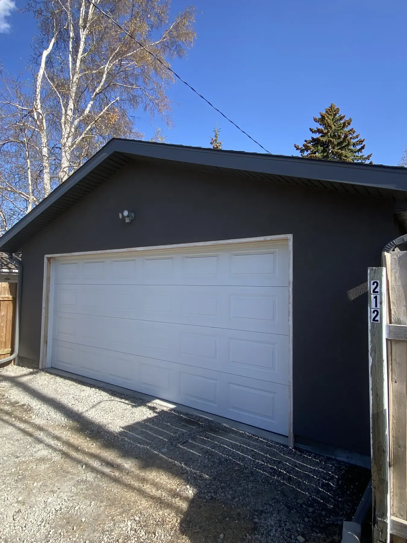 Detached garage in dark grey stucco