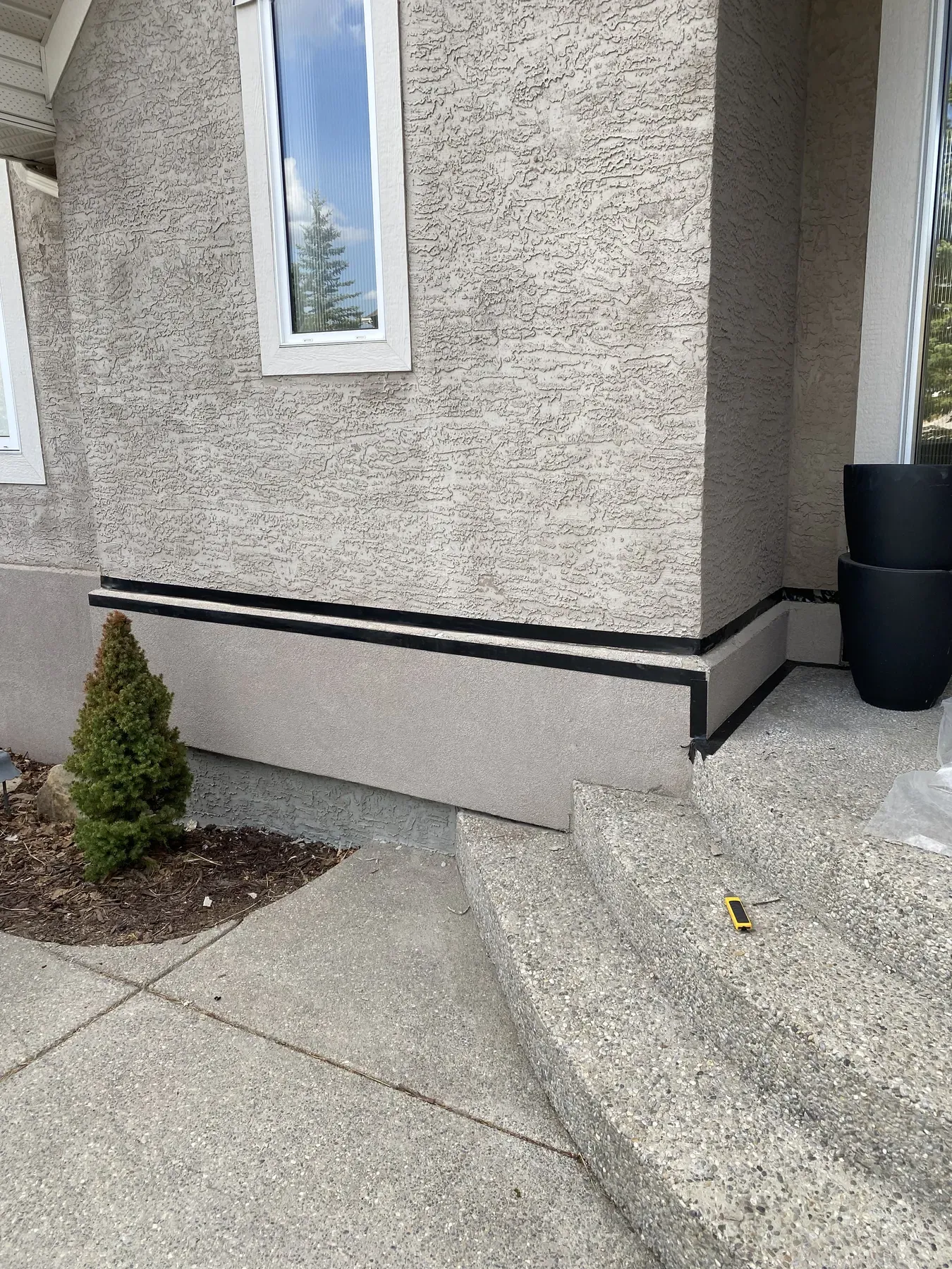 Stucco trim bands at a finished entry