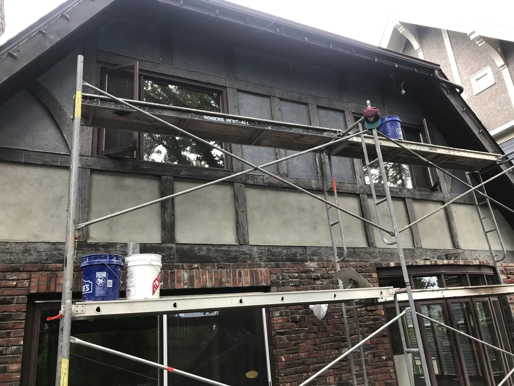 Tudor style home under scaffolding